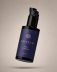 A 100 ml bottle of Divinum Mira Cleanser floating against a neutral beige background. The bottle is dark purple with a violet pump dispenser and features cream text and logo.