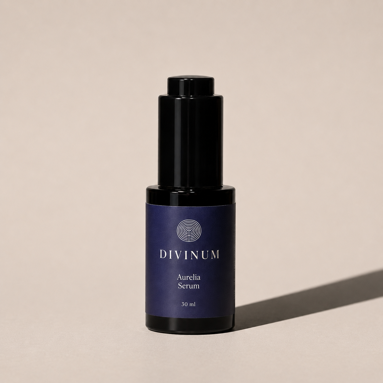 A 30 ml bottle of Divinum Aurelia Serum, featuring a dark purple label and a black dropper cap, set against a warm beige background with a soft shadow.