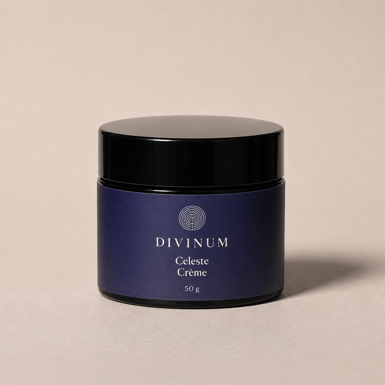 A 50g jar of Divinum Celeste Crème cosmetic cream, featuring a deep purple label and a black lid, set against a warm beige background.