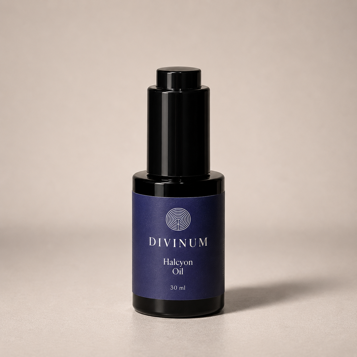 A 30 ml bottle of Divinum Halcyon Oil, featuring a dark purple label and a black dropper cap, set against a neutral beige background.