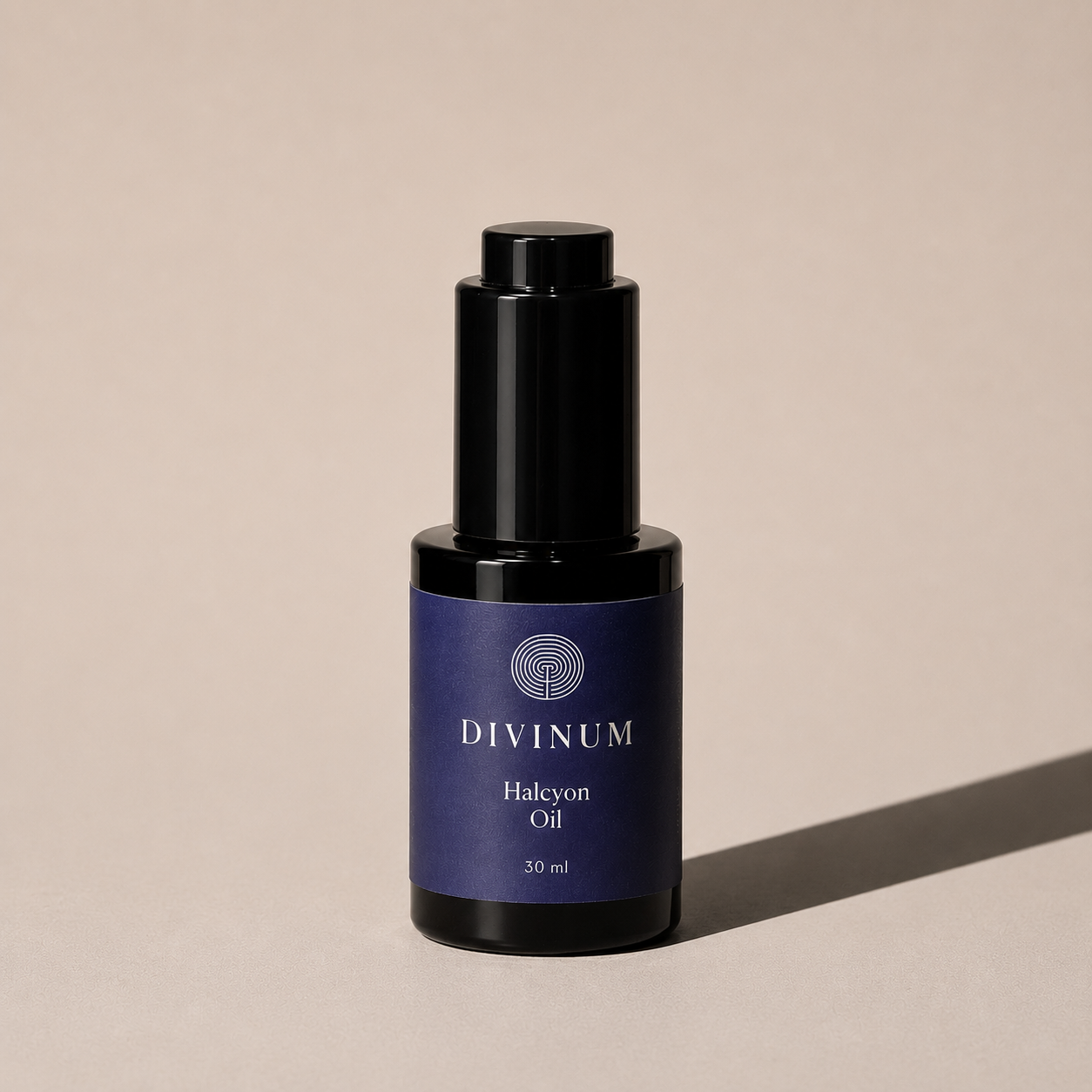 A 30 ml bottle of Divinum Halcyon Oil, featuring a dark purple label and a black dropper cap, set against a warm beige background with a soft shadow.