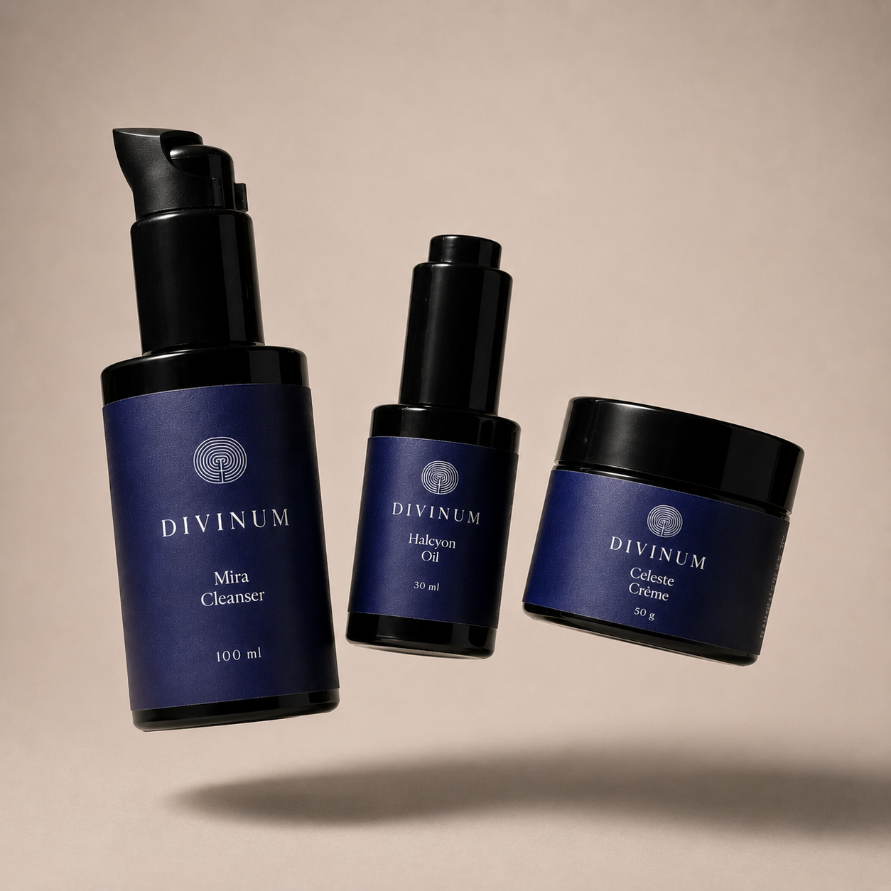 Three Divinum skincare products floating against a warm beige background: a large Mira Cleanser pump bottle, a smaller Halcyon Oil dropper bottle, and a Celeste Creme jar, all in dark violet and black packaging.