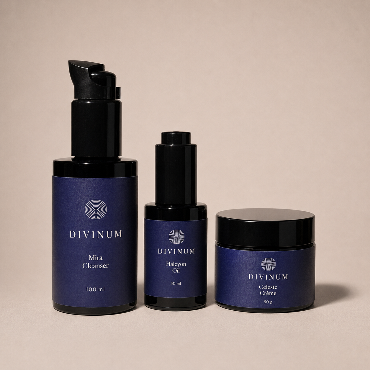 Three Divinum skincare products arranged against a solid beige background: a large black pump bottle of Mira Cleanser, a black dropper bottle of Halcyon Oil, and a black-lidded jar of Celeste Crème.